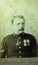 Vintage black and white photo of a man in military uniform with campaign medals, Star of India? Medic World War.