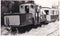 Vintage black and white photo of steam locomotive with driver and passengers 1950s