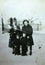 Vintage black and white photo of women and children in the snow, 1950s European.