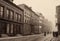 Vintage black and white (sepia) photograph of the old town of the 19th century with fog and smoke