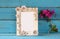 Vintage blank frame next to beautiful purple mediterranean summer flowers. template, ready to put photography