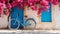 Vintage Blue Bicycle Against Vibrant Bougainvillea in European Village