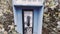 Vintage Blue outdoors public payphone booth close up