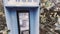 Vintage Blue outdoors public payphone booth side view