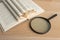 Vintage book and magnifying glass on wooden table. Education background. World books day