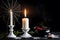 Vintage brass candelabra of five burning candles with dripping wax on a black background vertical background. photo