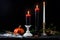 Vintage brass candelabra of five burning candles with dripping wax on a black background vertical background. photo