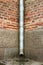 Vintage brick wall with drainpipe