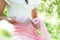 Vintage bride in gloves in a white-pink dress with a retro brooch