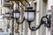 Vintage bronze white street lights in a row on the wall of the h