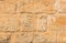 Vintage brown block shaped stone wall background texture, close-up