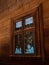 Vintage brown country wooden window. Antique traditional building exterior detail. Travel photo. Retro rustic wood board