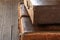 Vintage brown old faded suitcases stack luggage travel design on a dark background