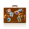Vintage brown threadbare suitcase with collection of retro grunge vacation & travel labels