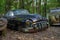 Vintage Buick Super Eight from 1950 left to nature overgrown with moss