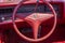 Vintage Cadillac Eldorado interior - steering wheel with logo and dashboard (focus on steering wheel