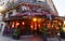 The vintage cafe Comptoir decorated with flowers at night , Paris, France