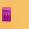 Vintage calculator on bright yellow background