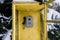 Vintage call-box, yellow telephone booth, a retro payphone