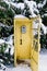 Vintage call-box, yellow telephone booth, a retro payphone