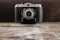 Vintage camera on dark wood background