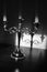 Vintage candlestick with three candles on the table. Shadow reflection on the wall