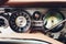 Vintage car dashboard with chrome rims speedometer tachometer.