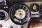 Vintage car dashboard with chrome rims speedometer tachometer.