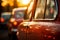 Vintage car headlights with beautiful blurred bokeh effect of vibrant sunset in the background