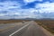 A vintage car traveling along the  US route 50 known as the Loneliest Road in America in the State of Nevada