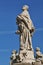 Vintage carved grey stone statue on the background of blue sky