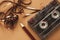 Vintage cassette and pencil to rewind tape on brown background