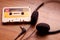 Vintage cassette tape and Retro headphone on wooden background, gadgets for The 70-80-90`s