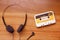 Vintage cassette tape and Retro headphone on wooden background, gadgets for The 70-80-90`s