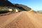 A vintage cattle grid and gate on a dirt road