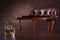 Vintage chair and glass of whiskey on wooden table