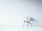 Vintage chair on the white wall. 3d render