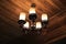 Vintage chandelier hanging on ceiling wooden.