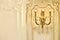 Vintage chandelier sconce lamp with candle lights on light wall