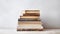 A vintage and charming image of a stack of old books on a white wooden table. The books are stacked in a pyramid shape