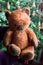 Vintage cheerful stuffed teddy bear toy under the christmas tree