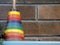 Vintage children`s toy against brick background. Assortment of color.