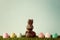 Vintage chocolate bunny with easter eggs over grass