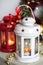 Vintage Christmas Lanterns Red and White with burning Candles. Cozy christmas decorations with golden beads, balls. Christmas tree