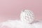 Vintage Christmas New Year balls in the snow on pink background Flat Lay copy space. Holiday Baubles, beautiful Decoration Festive