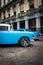 Vintage Chrysler next to old buildings in Havana