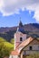 Vintage church in rimetea, alba county , Romania. Old building in the summer sun with green hills in the background.