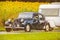 Vintage Citroen Traction Avant in front of a field with blooming