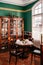 Vintage classic colonial restaurant dining room with wooden wine cabinet