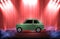 vintage classic green car with red curtain and spotlight showroom